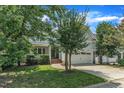 Traditional home with a charming two-car garage and mature landscaping at 500 Chandler Grant Dr, Cary, NC 27519