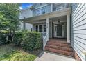 Inviting front entry featuring a brick staircase and covered porch at 500 Chandler Grant Dr, Cary, NC 27519