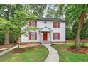Classic two-story house with red shutters, a red front door, and a well-maintained lawn and garden at 508 Bolin Creek Dr, Carrboro, NC 27510