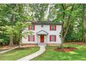 Two-story home with white siding, red shutters, landscaped yard, and a walkway leading to the front entrance at 508 Bolin Creek Dr, Carrboro, NC 27510