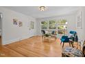 Bright living room with hardwood floors, large windows, and stylish decor at 5257 Vann St, Raleigh, NC 27606