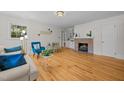 Cozy living room with a brick fireplace, hardwood floors, and natural light at 5257 Vann St, Raleigh, NC 27606