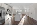 Modern kitchen featuring stainless steel appliances, granite countertops, and hardwood floors at 5324 River Reach Dr, Raleigh, NC 27616