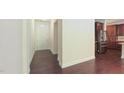Spacious foyer with hardwood floors leading to a kitchen area with dark cabinets and stainless steel appliances at 536 Rockcastle Dr, Cary, NC 27519