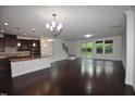 Spacious open floor plan showcasing beautiful hardwood floors and abundant natural light from large windows at 536 Rockcastle Dr, Cary, NC 27519