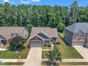 An aerial view showcases a well-maintained property with mature trees and manicured lawns in a suburban neighborhood at 601 Minerva Dale Dr, Fuquay Varina, NC 27526