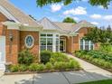 Beautiful brick home with manicured landscaping, large windows, and a welcoming entrance at 606 Corrigan Way, Cary, NC 27519