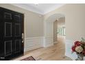 Inviting foyer with hardwood floors, elegant wainscoting, and an open view to the living spaces at 606 Corrigan Way, Cary, NC 27519