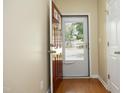 Inviting foyer with hardwood floors, neutral walls, a red front door and a view to the exterior at 617 Woodson Dr, Clayton, NC 27527