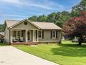 Charming single-story home with a well-maintained lawn, and a covered front porch at 635 Raymond Dr, Wendell, NC 27591