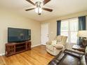 Cozy living room with hardwood floors, a ceiling fan, and a comfortable recliner at 635 Raymond Dr, Wendell, NC 27591