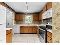 Well-lit kitchen featuring stainless steel appliances and tile flooring at 6422 English Oaks Dr, Raleigh, NC 27615