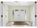Bright foyer featuring a double front door, decorative sidelights, tile flooring, and ample natural light at 6608 Quiet Cove Ct, Raleigh, NC 27612