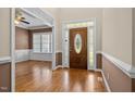 Elegant foyer with hardwood floors, decorative front door, and view into adjacent living space at 6965 Ogburn Farms Dr, Willow Springs, NC 27592