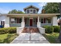 Charming craftsman home featuring a covered front porch with red shutters and brick-lined steps at 708 Parker St, Durham, NC 27701