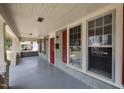 Inviting front porch features classic columns, red shutters, and ample natural light at 708 Parker St, Durham, NC 27701