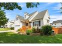 A charming home with a well-kept lawn and landscaping, featuring a cozy front porch and inviting curb appeal at 741 Rockville Rd, Wake Forest, NC 27587