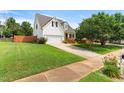 Beautiful home showcasing a spacious lawn, attached garage, and inviting front porch, perfect for suburban living at 741 Rockville Rd, Wake Forest, NC 27587