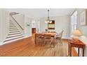 Dining room with hardwood floors adjacent to staircase and windows offering natural light at 8851 Mariner Dr, Raleigh, NC 27615