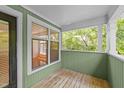 A balcony with green walls and a view of a lush green space at 1010 Nicholwood Dr # 301, Raleigh, NC 27605