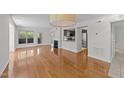 Open-concept living room with hardwood floors, fireplace, and view of the kitchen at 1010 Nicholwood Dr # 301, Raleigh, NC 27605