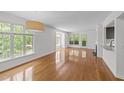 Bright living room with gleaming hardwood floors and ample natural light from large windows at 1010 Nicholwood Dr # 301, Raleigh, NC 27605