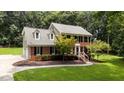 Well-maintained two-story home with brick accents, black shutters, and a lush green lawn at 10721 Marabou Ct, Raleigh, NC 27614