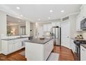 Spacious kitchen with granite countertops, stainless steel appliances, and large center island at 108 Market Cross Ct, Holly Springs, NC 27540