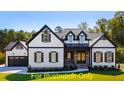 New construction home with black trimmed windows, wood shutters and a two car garage at 110 Broadleaf Ln, Louisburg, NC 27549