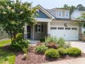 Charming home featuring an attached two car garage and meticulously landscaped front yard at 12421 Angel Vale Pl, Durham, NC 27703