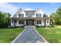 Charming two-story home boasting a gray stamped concrete walkway and lush green lawn at 125 Attena Way, Zebulon, NC 27597