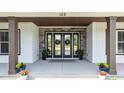 Elegant entryway with a double door, stone accents, and decorative wreaths at 125 Attena Way, Zebulon, NC 27597