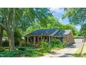 Beautiful brick home with a well-manicured lawn, charming front porch, and lovely landscaping at 1311 Norton St, Durham, NC 27701