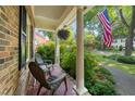 Cozy covered porch with comfortable seating and views of the lush, landscaped front yard at 1311 Norton St, Durham, NC 27701