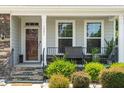 Inviting front porch area with seating and decorative landscaping at 1321 White Spruce Dr, Willow Springs, NC 27592