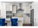 Stylish kitchen with white cabinets, stainless steel appliances, and an island with seating at 1321 White Spruce Dr, Willow Springs, NC 27592