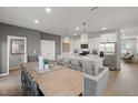 Open-concept kitchen and dining area with stainless steel appliances and center island at 1472 Hasse Ave, Apex, NC 27502