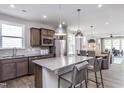 Modern kitchen featuring a large center island, stainless steel appliances, and stylish pendant lighting at 181 Churchill Way, Clayton, NC 27520