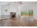 Spacious living room featuring a stone fireplace and access to the outdoor patio at 200 Whistlers Cv, Louisburg, NC 27549