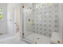 Bathroom with a glass-enclosed shower featuring a patterned tile wall at 200 Whistlers Cv, Louisburg, NC 27549