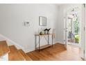 Bright and airy foyer with hardwood floors, console table, and an open doorway to the outside at 204 Towne Ridge Ln, Chapel Hill, NC 27516