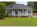 Charming single-story home with gray siding, black shutters, and a welcoming front porch at 204 Valley Ct, Selma, NC 27576