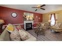 Inviting living room featuring a cozy fireplace, stylish furnishings, and bright, airy ambiance at 205 Cedar Dr, Zebulon, NC 27597