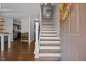 Open entryway with hardwood floors, staircase, and natural light, creating a welcoming and spacious entrance at 206 Vandercroft Way, Bunnlevel, NC 28323