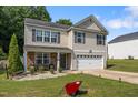 Lovely two-story home with a welcoming front porch and lush green lawn, offering a cozy suburban lifestyle at 206 Vandercroft Way, Bunnlevel, NC 28323