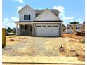 Charming two-story home with a two-car garage and well-manicured lawn on a sunny day at 21 Windflower Ct # Homesite 11, Clayton, NC 27520