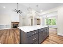 Open-concept kitchen with white countertops, stainless steel appliances and large center island with seating at 225 Whistlers Cv, Louisburg, NC 27549