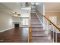 Cozy living room with hardwood floors, fireplace, and staircase to the second floor at 2430 Josephine Rd, Garner, NC 27529