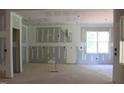 Spacious living room showing the construction with large windows providing natural light at 25 Autumnwood Ln, Spring Hope, NC 27882