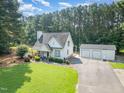 Charming home with well-manicured lawn and a detached two-car garage at 255 Morris Rd, Pittsboro, NC 27312